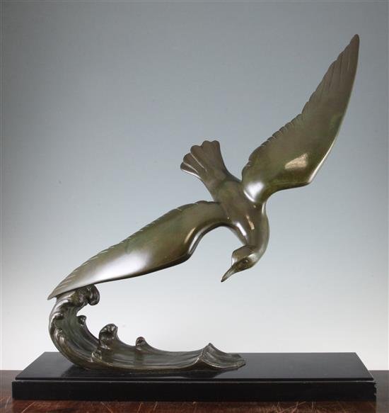 L. Alliot. A French Art Deco patinated bronze model of a sea bird on the crest of a wave, 24.75in.